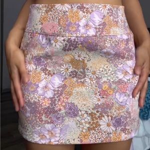 Size small skirt but fits more like a medium. Floral pattern and zips on side